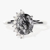 Oval Black Rutilated Quartz Engagement Ring with Round Moissanite Sidestones.