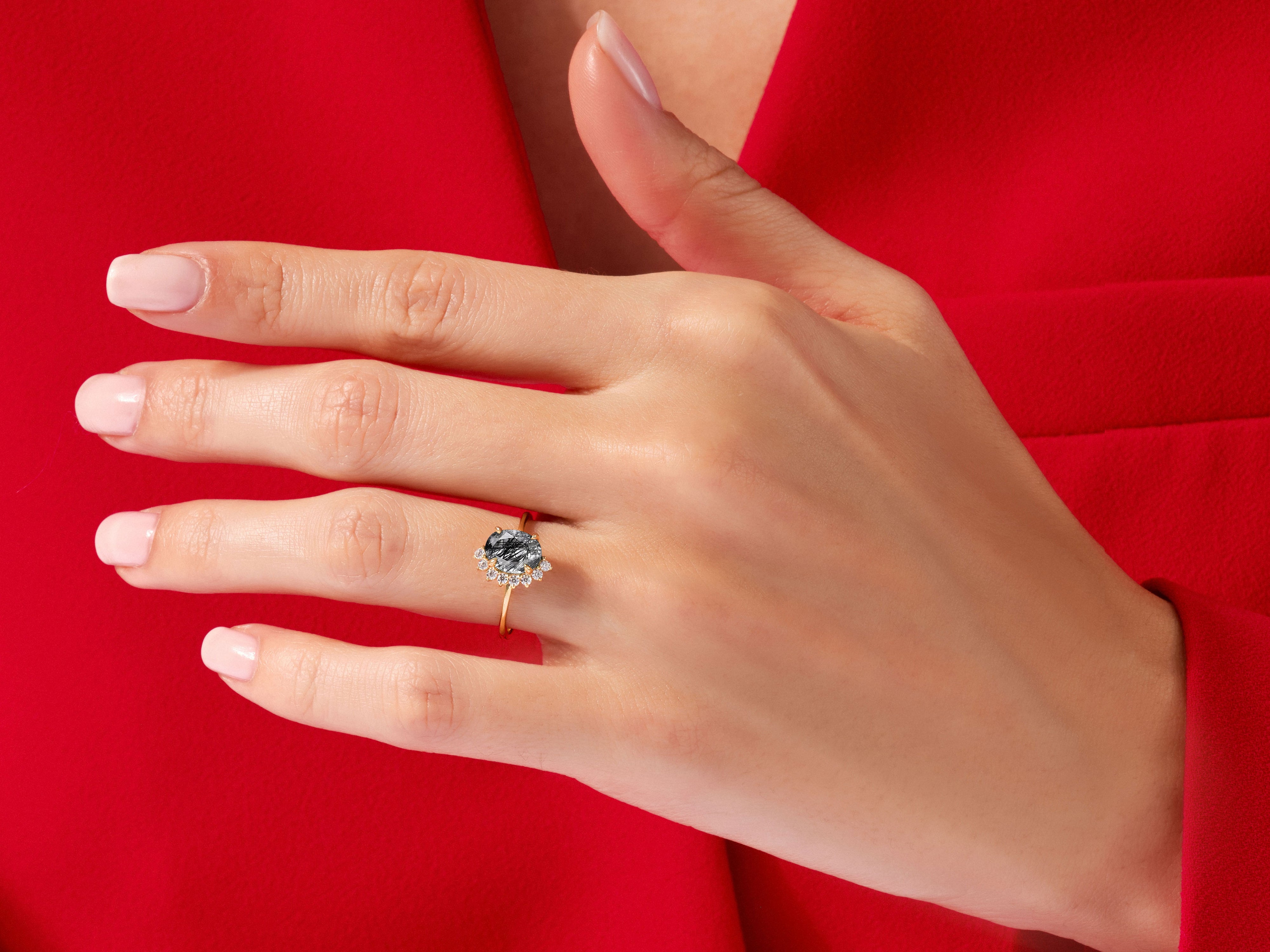 Oval Black Rutilated Quartz Engagement Ring with Round Moissanite Sidestones.