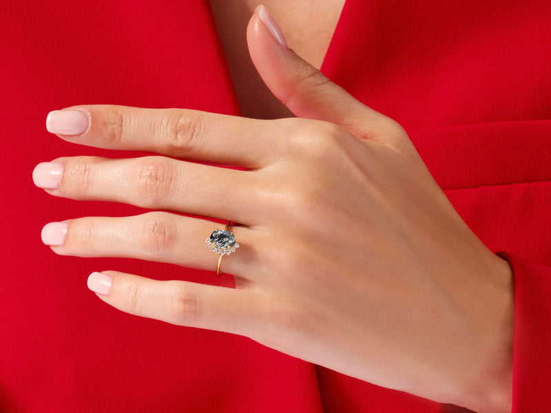 Oval Black Rutilated Quartz Engagement Ring with Round Moissanite Sidestones.