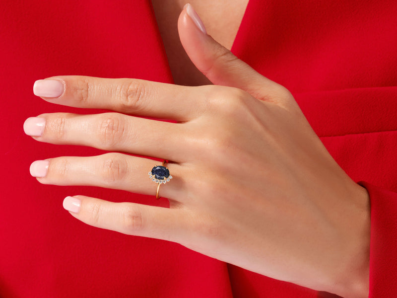 Oval Blue Sandstone Engagement Ring with Round Moissanite Sidestones.