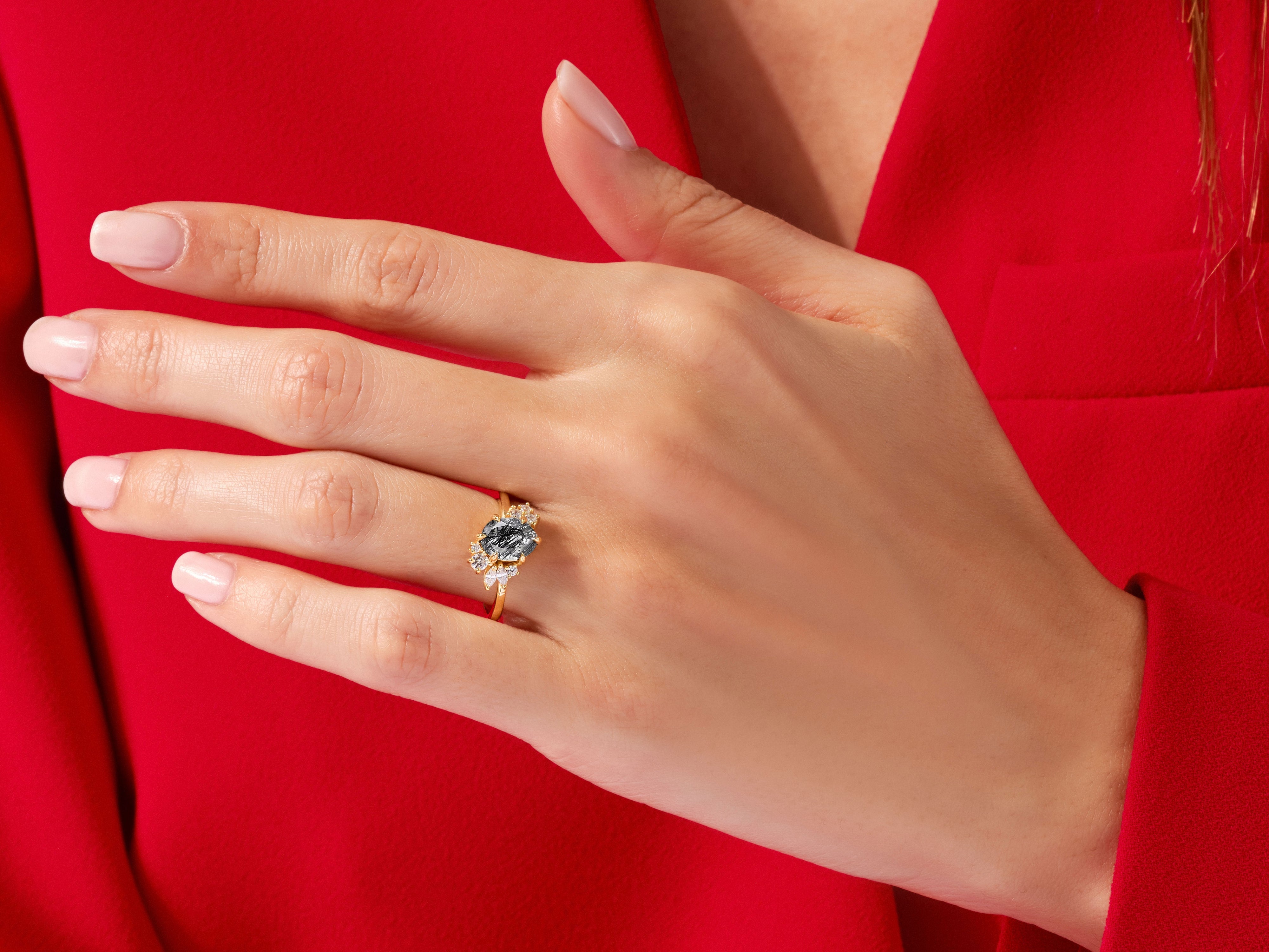 Oval Black Rutilated Quartz Engagement Ring with Round Moissanite Cluster.