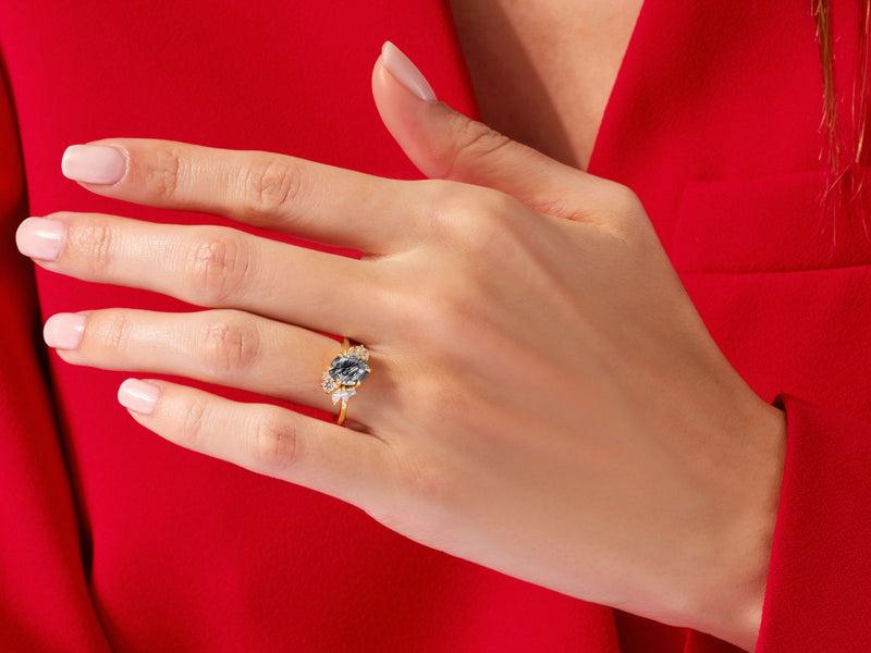 Oval Black Rutilated Quartz Engagement Ring with Round Moissanite Cluster.