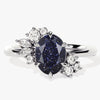 Oval Blue Sandstone Engagement Ring with Round Moissanite Cluster.