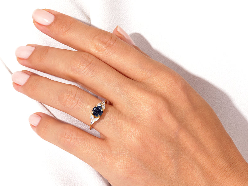 Round Blue Sandstone Engagement Ring with Pear Moissanite Sidestones.