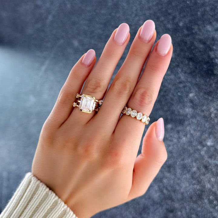 Modern Minimalism: Emerald Cut Half Bezel Ring with Baguettes